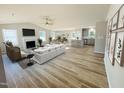 Bright, open-concept living space with fireplace, large windows, and adjacent kitchen with bar seating at 107 Earnest Way, Kenly, NC 27542