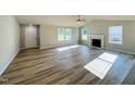 Spacious living room with a fireplace, ceiling fan, and plenty of natural light at 107 Earnest Way, Kenly, NC 27542