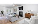 Bright living room with fireplace, hardwood floors, modern furniture, and french doors leading to the outside at 110 Stoney Dr, Durham, NC 27703
