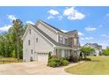 A beautifully landscaped home features a two-car garage and meticulous lawn care at 113 Old Ballentine Way, Holly Springs, NC 27540