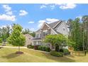 Well maintained lawn with mature trees and shrubbery that enhances the curb appeal of this home at 113 Old Ballentine Way, Holly Springs, NC 27540