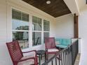 Cozy porch features rocking chairs, a loveseat, and views of the surrounding landscape at 1180 Duke Farm Dr, Wake Forest, NC 27587