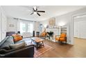 Bright living room with hardwood floors, a fireplace, and neutral-toned furnishings at 1209 Eva St, Durham, NC 27703