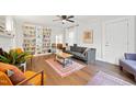 Inviting living room featuring hardwood floors, a large built-in bookshelf, and ample natural light at 1209 Eva St, Durham, NC 27703