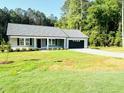 Traditional single-story home featuring a well-kept front lawn and lovely landscaping at 121 Earnest Way, Kenly, NC 27542