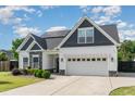 Charming two-story home featuring a mix of siding, stone accents, and a well-manicured lawn at 123 Jonalker Ct, Clayton, NC 27520