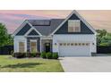 Charming single-Gathering home featuring stone accents, a two-car garage, and well-manicured lawn at 123 Jonalker Ct, Clayton, NC 27520