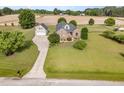 Stunning aerial view of a brick two-story home with a manicured lawn and detached garage at 130 Skipwith Dr, Wendell, NC 27591