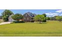Inviting brick home on a large lot with well-maintained lawn and established trees at 130 Skipwith Dr, Wendell, NC 27591