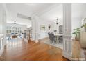 Open-concept home featuring hardwood floors, decorative columns, and spacious living areas with ample natural light at 1328 Palace Garden Way, Raleigh, NC 27603