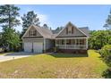 Attractive house with a two-car garage, quaint front porch, and lush green yard at 15 Clearwater Harbour Hbr, Sanford, NC 27332