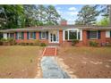 Charming brick home featuring a bay window and meticulously maintained landscaping at 1502 Washington St, Durham, NC 27701