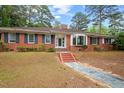 Attractive brick home featuring a bay window and meticulously maintained landscaping at 1502 Washington St, Durham, NC 27701