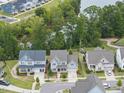 Lovely home with a manicured yard in a neighborhood near a pond surrounded by trees at 1605 Silo Point Dr, Wake Forest, NC 27587