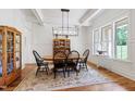 Elegant dining room with coffered ceiling, wainscoting, chandelier, and large windows at 197 Boxwood Dr, Pittsboro, NC 27312