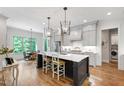 Bright, open kitchen with a large island, pendant lighting, stainless appliances, and hardwood floors at 197 Boxwood Dr, Pittsboro, NC 27312