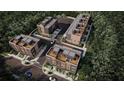 An aerial view of modern townhomes shows rooftop terraces, lush greenery, and a well-designed community layout at 210 Byrum St # 6, Cary, NC 27511
