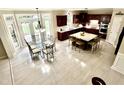 Open dining area with a glass table, wood floors, and natural light from French doors at 210 Shillings Chase Dr, Cary, NC 27518