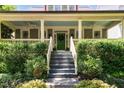 Beautiful front porch with ceiling fans, columns, and a welcoming green door with decorative wreath at 2205 Karns Pl, Raleigh, NC 27614