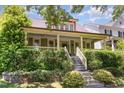 Inviting home with a lovely front porch, stairs and lush landscaping at 2205 Karns Pl, Raleigh, NC 27614