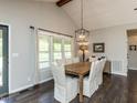 Dining room features a large window and dark wood floors at 235 Stephenson Rd, Benson, NC 27504