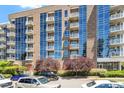Building exterior with balconies surrounded by beautiful green trees at 2410 Environ Way, Chapel Hill, NC 27517