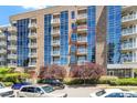 Building exterior with balconies surrounded by beautiful green trees at 2410 Environ Way, Chapel Hill, NC 27517