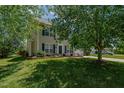 Inviting two-story home with lush green lawn and blue shutters on the windows providing great curb appeal at 2412 Chartwell Ln, Graham, NC 27253