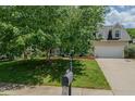 Well-maintained two-story home with an attached garage and a lush green lawn in a desirable neighborhood at 2412 Chartwell Ln, Graham, NC 27253