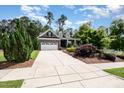 Well-maintained home featuring a stone facade, two-car garage, and lush landscaping, creating a welcoming curb appeal at 2421 Beckwith Rd, Apex, NC 27523