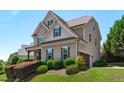 Charming two-story home featuring an attached garage and beautifully landscaped front yard with manicured shrubbery at 2712 Peachleaf St, Raleigh, NC 27614