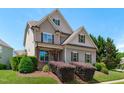 Inviting two-story home with a covered front porch, manicured landscaping, and lush green lawn at 2712 Peachleaf St, Raleigh, NC 27614