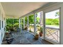Spacious screened porch with slate flooring, ceiling fan and nice furnishings at 2725 Bedford Ave, Raleigh, NC 27607
