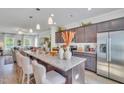 Kitchen with granite counters, stainless appliances, island seating, and a view into the living room at 294 Alice Trace Place, Angier, NC 27501