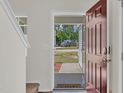 Inviting entryway featuring a stylish door, wood floors, and a view of the outdoor scenery at 3040 Varcroft Rd, Knightdale, NC 27545
