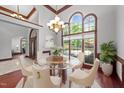 Bright formal dining area with clear table and six chairs and large windows at 308 Thomas Dr, Clayton, NC 27520