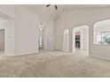 Spacious living room with a vaulted ceiling, multiple doorways, and lots of natural light at 309 Coachman'S Trl, Stem, NC 27581