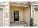 Covered front entrance featuring a black front door with sidelights and house number at 3623 Landshire View Ln, Raleigh, NC 27616