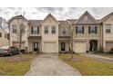 A row of beautifully designed townhomes with individual garages, driveways, and manicured lawns at 3623 Landshire View Ln, Raleigh, NC 27616