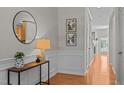 Elegant foyer showcasing classic wainscoting, wood floors, and stylish decor at 3711 Ramblewood, Durham, NC 27713