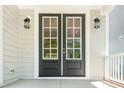 Close up of the front door with glass panels and a sidelight at 407 Carolina Ave, Raleigh, NC 27606