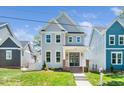 Charming two-story home featuring light gray siding and a well-manicured front lawn at 407 Carolina Ave, Raleigh, NC 27606