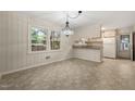 Dining area featuring classic chandelier, neutral color palette, and access to the kitchen, perfect for entertaining at 413 Winterlochen Rd, Raleigh, NC 27603