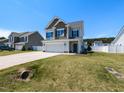 Beautiful two-story home with a well-kept lawn and a long driveway on a sunny day at 43 Jonalker Ct, Clayton, NC 27520