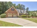 Attractive brick home with a two-car garage, dormer windows, and well-manicured landscaping at 4420 Dula St, Durham, NC 27705