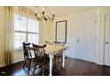 Cozy dining room featuring a rustic table, chandelier, and large window offering ample natural light at 50 Waterford Dr, Angier, NC 27501