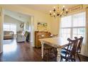 Well-lit dining area with vintage chandelier, table and view to living room beyond at 50 Waterford Dr, Angier, NC 27501
