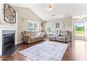 Spacious living room with hardwood floors, fireplace, and two sofas under natural lighting at 50 Waterford Dr, Angier, NC 27501
