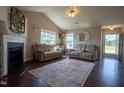 Inviting living room features vaulted ceilings, fireplace, and two comfortable sofas at 50 Waterford Dr, Angier, NC 27501