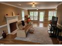 Spacious living room boasts natural light, a fireplace, and comfortable seating for relaxing and entertaining at 501 Samara St, Apex, NC 27502